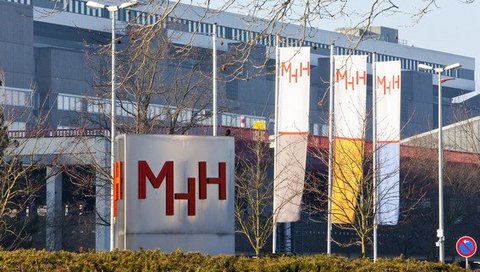 MHH main entrance with metal stele and flagpoles. 
