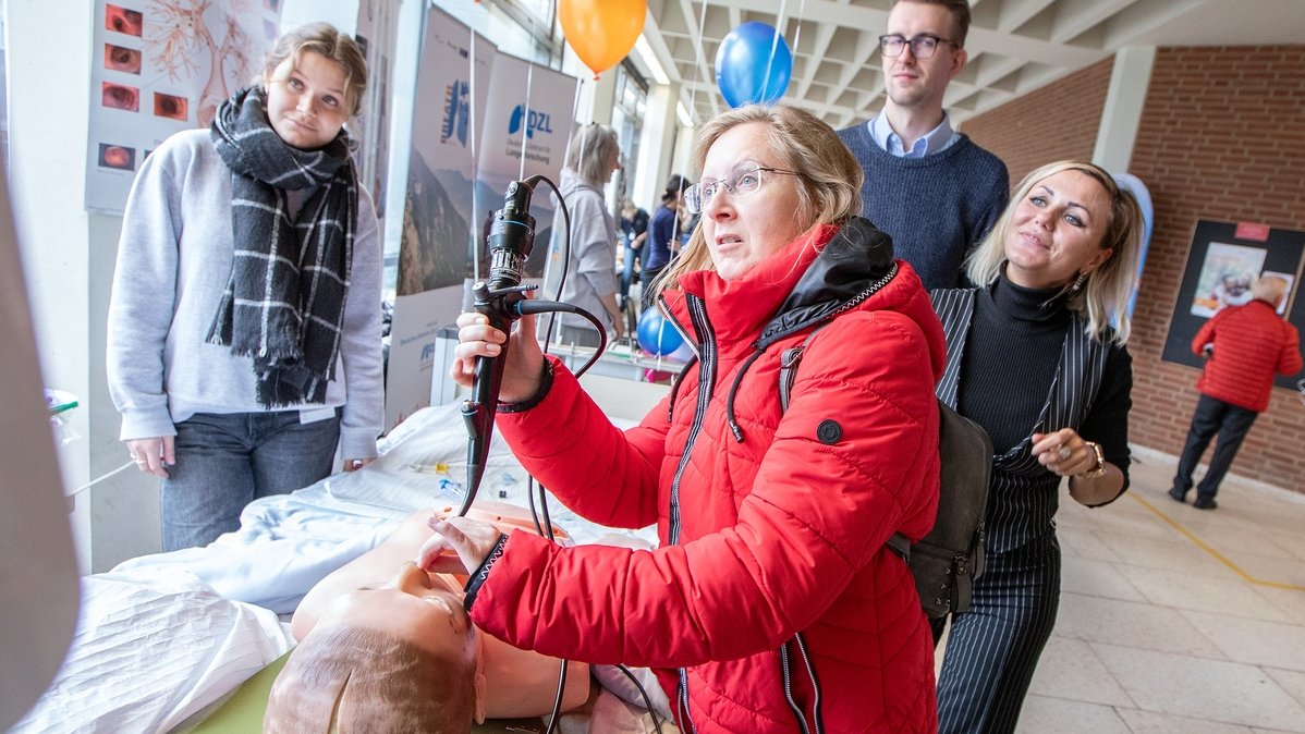 A woman tests a bronchoscopy on a demonstration dummy at the open day.