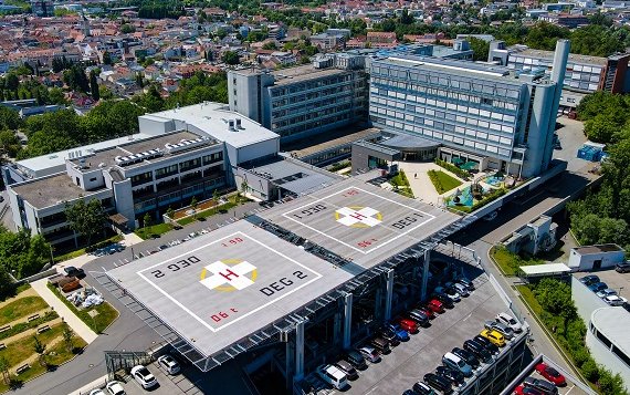 Im Vordergrund ist ein Hubschrauberlandeplatz zu sehen, im Hintergrund das Donau-Isar-Klinikum Deggendorf.