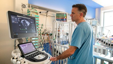 A doctor stands in front of an ultrasound machine in the MHH paediatric clinic.