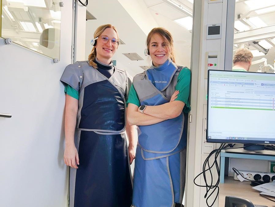 Two female physicians at the door to a cardiac catheterization lab