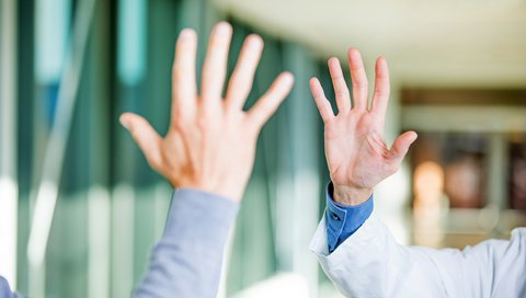 Two palms are raised to the gesture “Gimme five!”