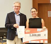 student receives cheque from speaker of the programme