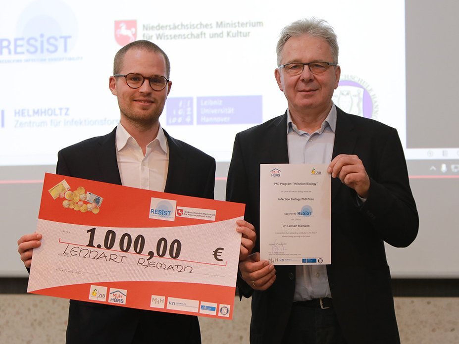 student receives cheque from speaker of the programme