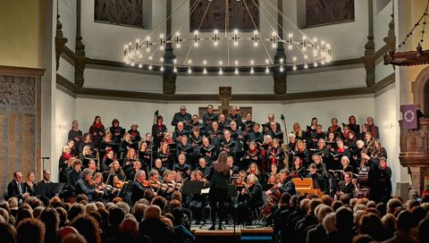 an orchestra plays in front of people