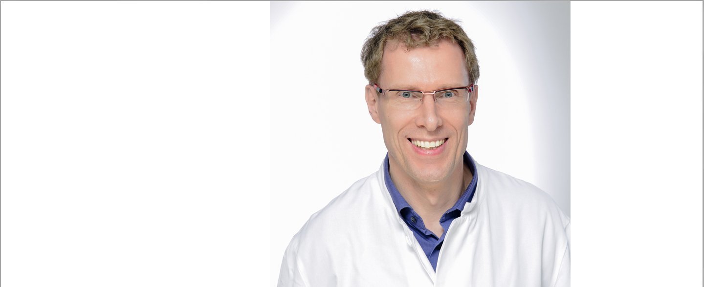 A smiling doctor. 
