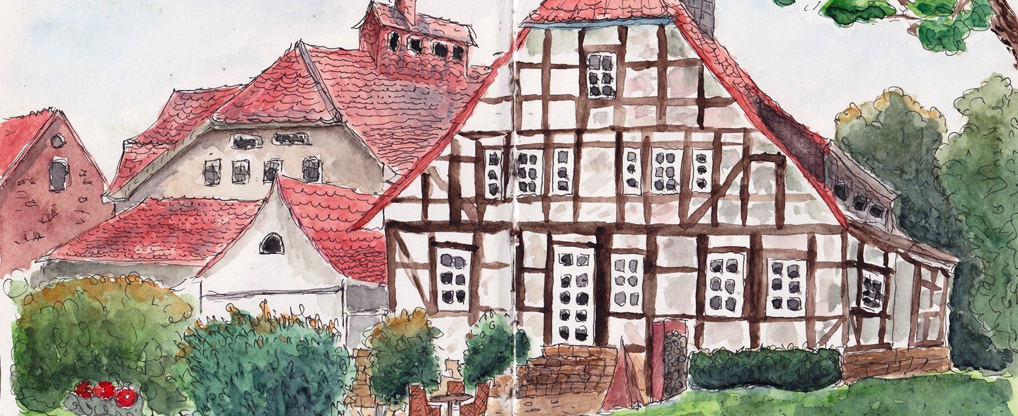 Die Zeichnung eines Fachwerkhauses mit Hof. 