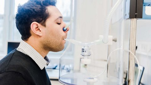 A test person is inhaling a vaccine.