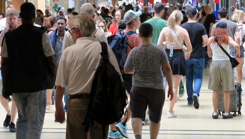 The photo shows a crowd of people in the city.