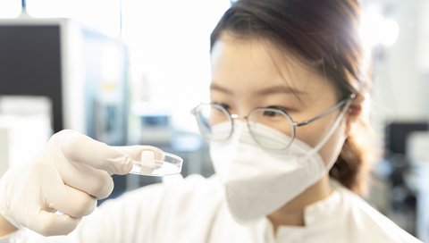 It shows hearing researcher Yanjing Luo with the ear canal implant