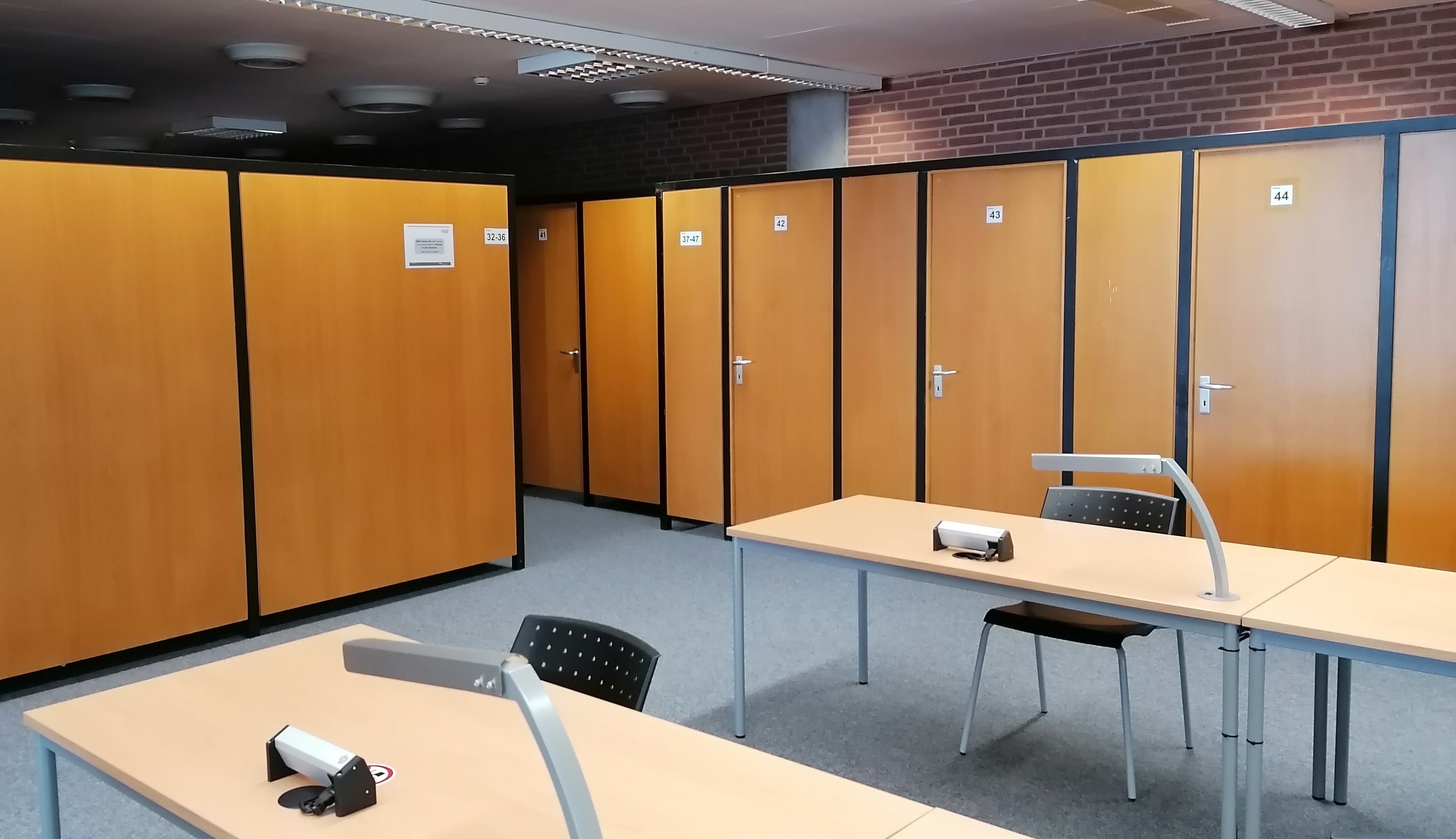 several study booths in the upper reading room of the library