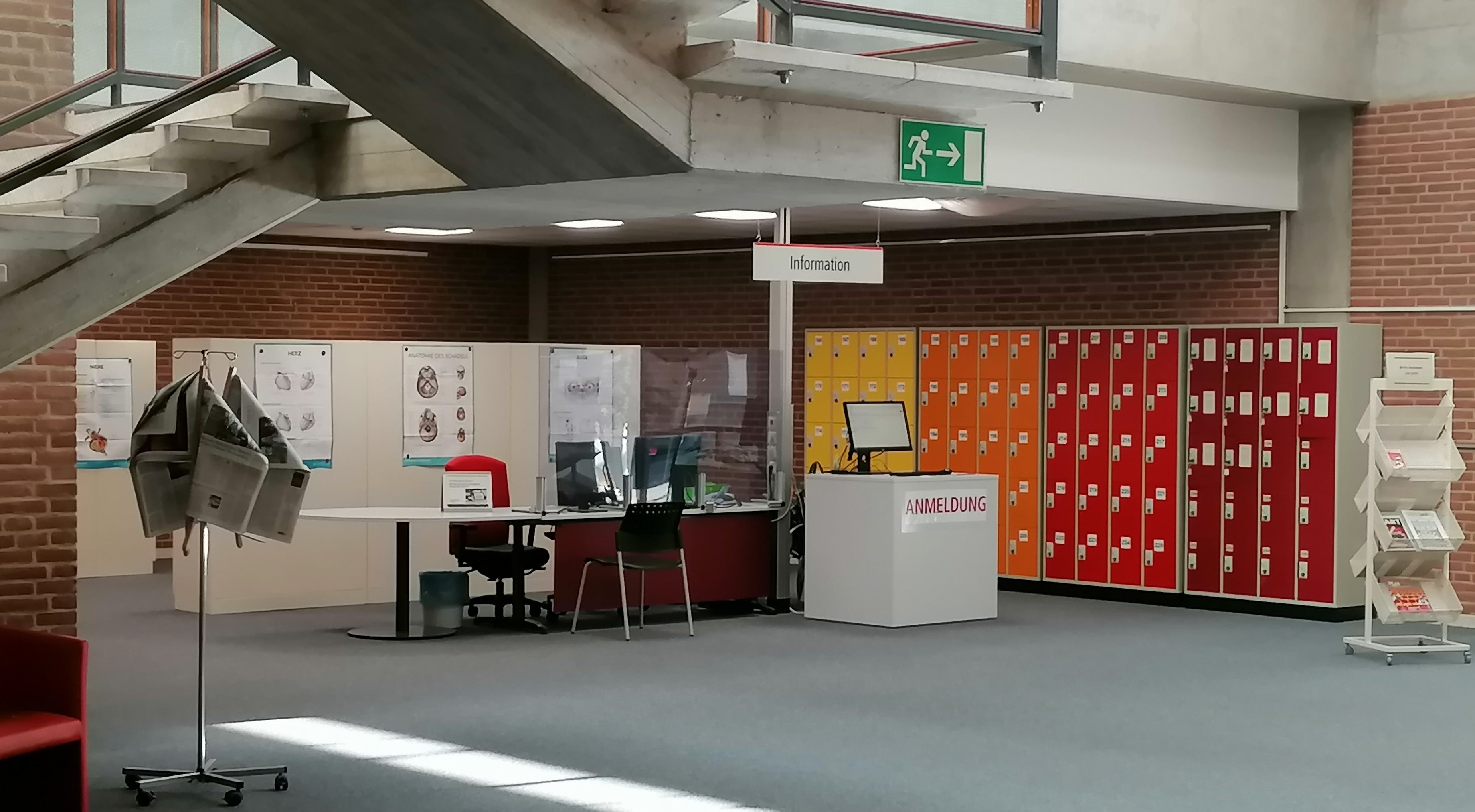 Information desk in the foyer of the library with  lockers  in the background