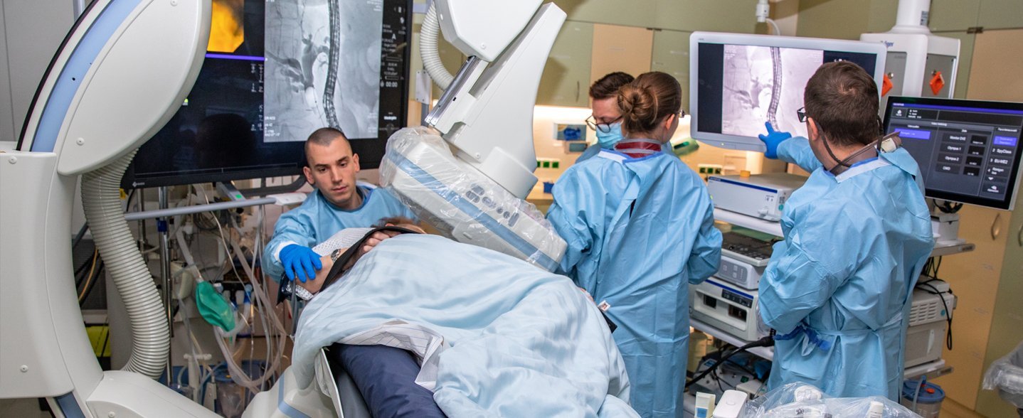 During a bile duct endoscopy poeple are looking at a screen. 