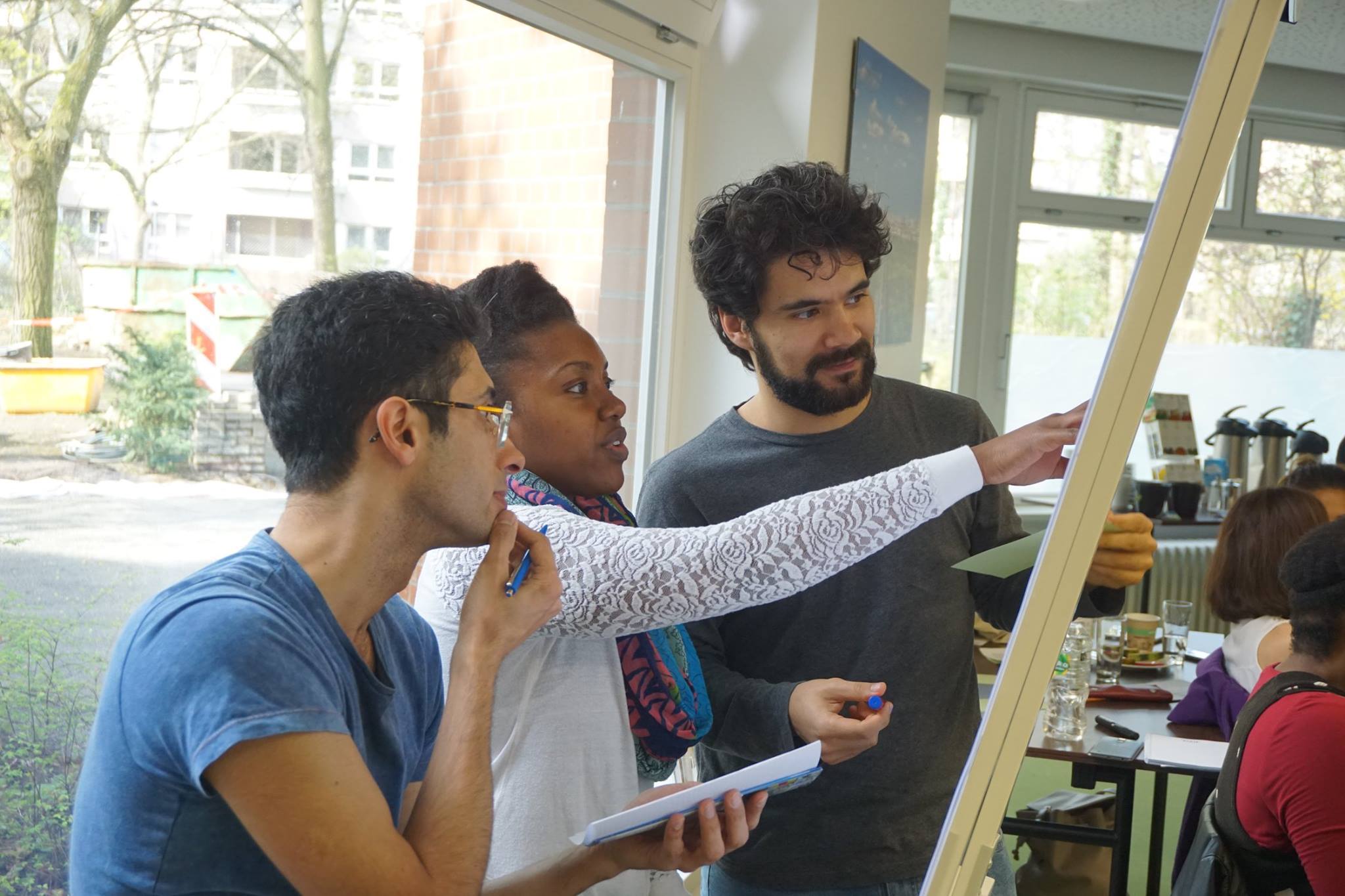 picture of three PhD students dicussing a poster