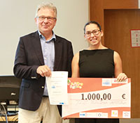 student receives cheque from speaker of the programme