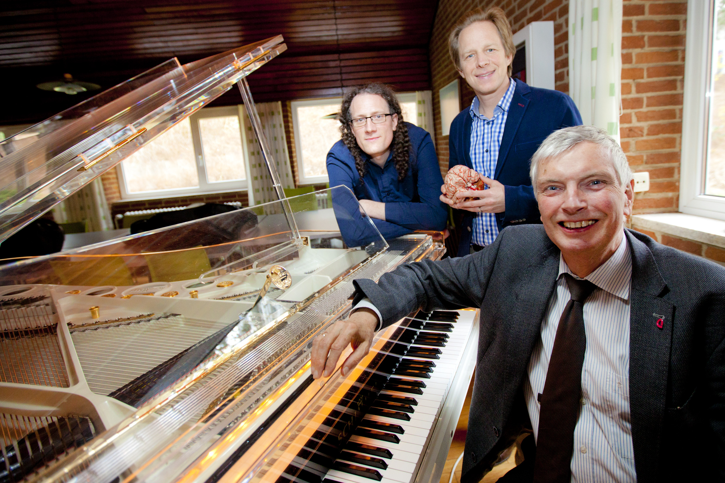 Drei Wissenschaftler an einem Pianoflügel