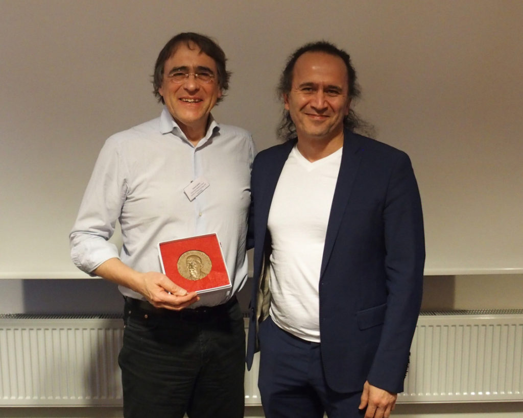 Poulsson prize 2022. Left: Prof. Seifert holding the medal; right: Prof. Sharikabad, President of the NSFT