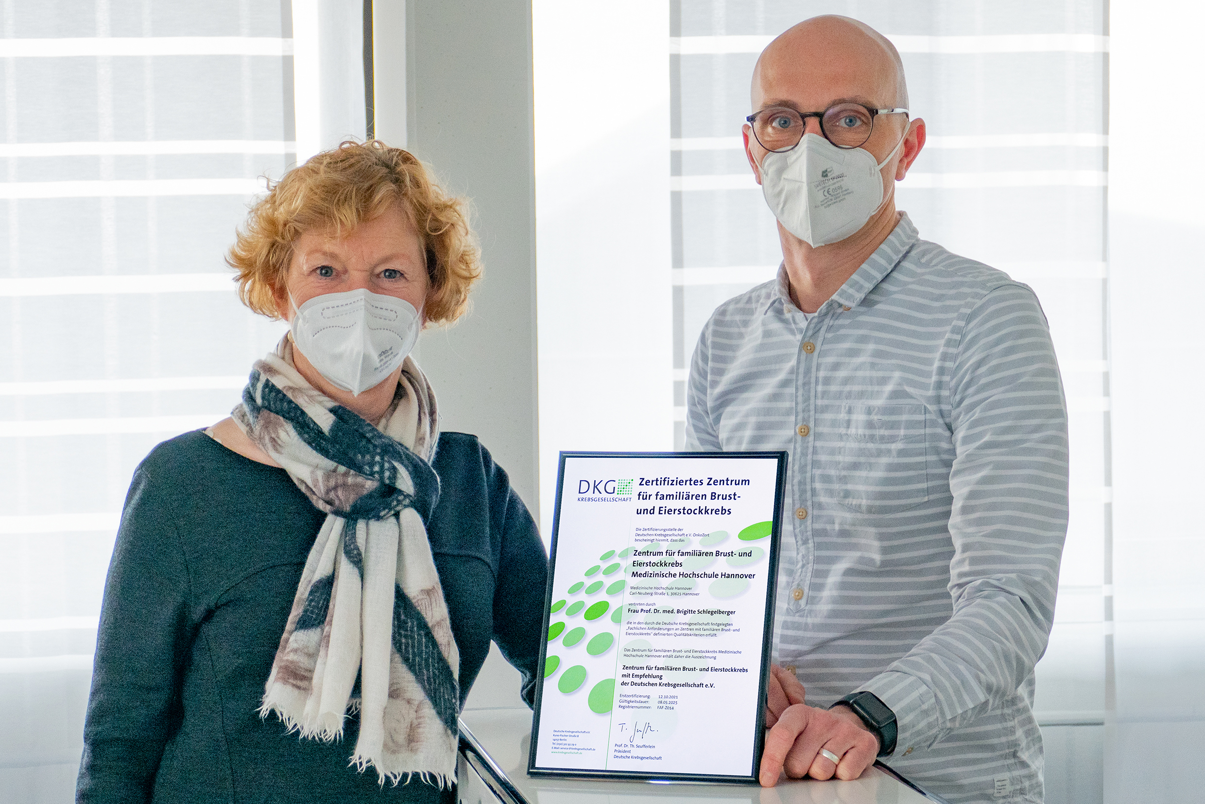 Professor Dr Brigitte Schlegelberger and Dr Tim Ripperger show the certificate stating that the centre has been certified.