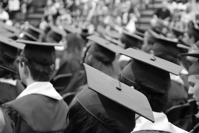 A group of people wearing a doctoral hat. The image is black and white.